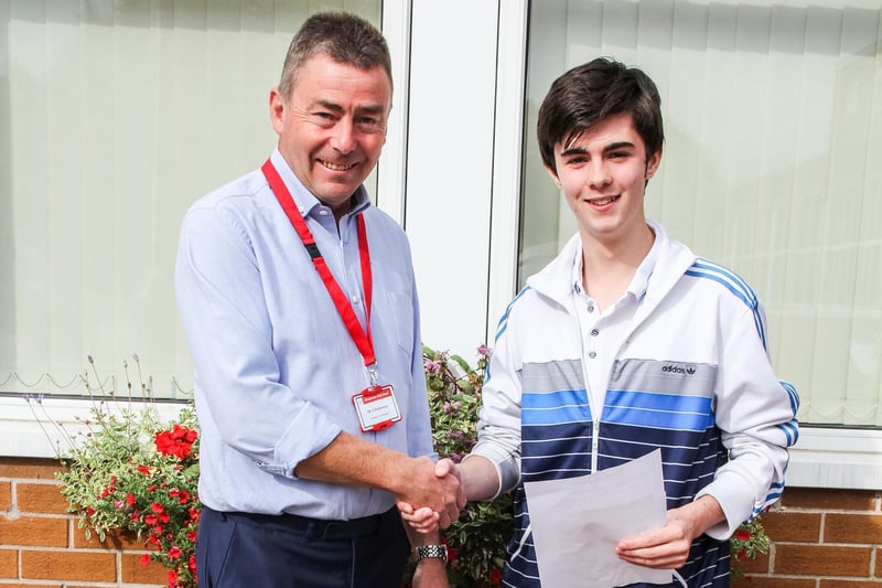 Mr. Patterson, teacher at Glengormley High School congratulating Dylan Osborne with his GCSE results of 5As, 2Bs and 1C in 2015. INNT 34-504-SO