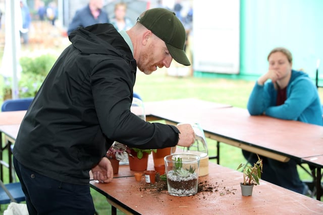 Pictured at the gardening festival are is Conrad McCormick demonstrating how to make a terrarium.