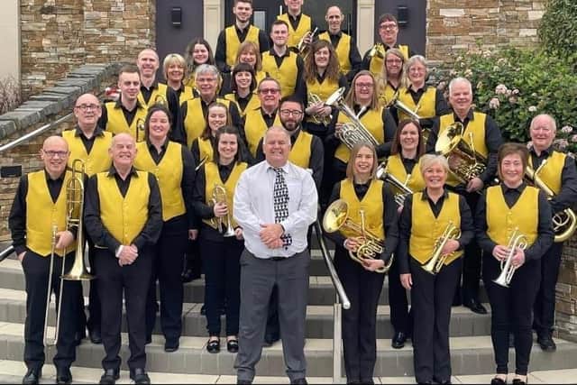 Lisburn band Dynamic Brass celebrates its tenth anniversary with new uniforms