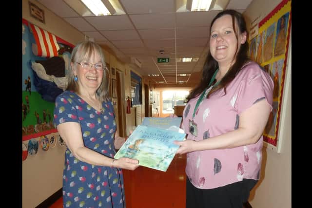 Marianne presented teacher Emma McMaster with copies of her books ‘Ronan and the Mermaid’ and ‘The Fog Catcher’s Daughter’ for the school library. Photo: Supplied