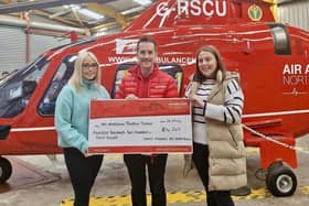Megan and Jemma Newell, Coagh present a cheque for £14,240 to Damien McAnespie from Air Ambulance NI Charity following a coffee morning and raffle held at Donaghendry Parish Church, Stewartstown in memory of their late brother Adam Newell on what would have been his 21st birthday. Credit: Supplied