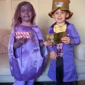 Daisy and Jack Robinson dressed as Willy Wonka and Violet Beauregarde from Charlie and the Chocolate Factory.