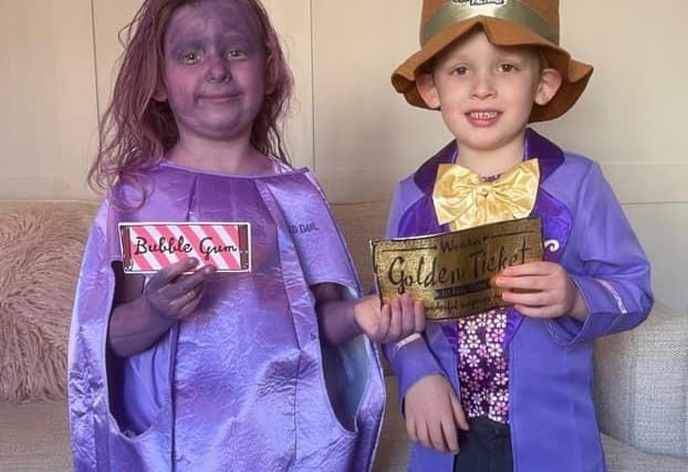 Daisy and Jack Robinson dressed as Willy Wonka and Violet Beauregarde from Charlie and the Chocolate Factory.