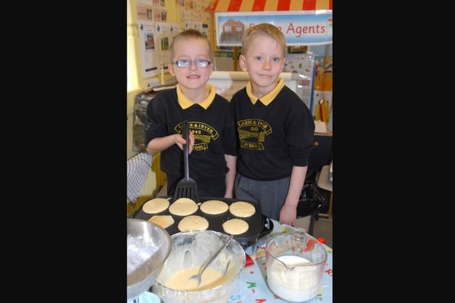 Regan and Reuben flip their pancakes during Pancake Day at Larne and Inver Primary School in 2011.
