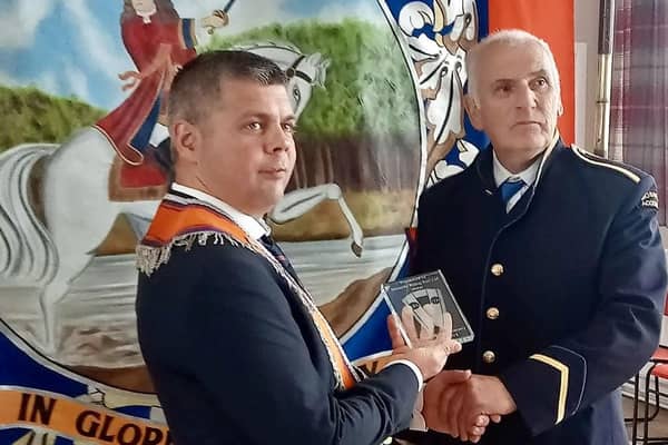 Worshipful Master Bro Nicholl pictured presenting Danny with a crystal gift to mark 60 years in the band. CREDIT MCAULEY MULTIMEDIA