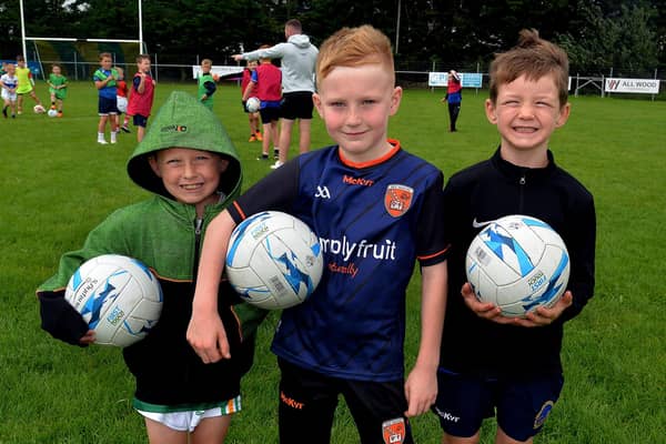 Three of the boys who took part in a football coaching session at the Healthy Kidz Summer Camp. PT31-214.