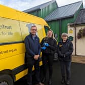 Keith Buchanan is pictured with Sarah Parks Assistant Manager Administration (holding Oscar) and Marbeth Gilmour, Assistant Manager Operations at Ballymena Rehoming Centre.
