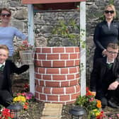 The Well, adorned with vibrant flowers, ranked highly in each category of the voting. Dominic and Caolan along with their key adult Dearbhail, are congratulated for their innovative thinking and team work to lift first place in the flowerbed competition. Credit: Holy Trinity College