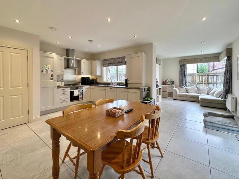 Amazing open plan kitchen/dining and living area with patio doors from sunroom.