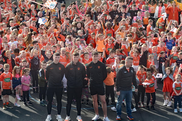 Three members of the Armagh GAA squad were special guests at St John The Baptist Primary School's Armagh Day on Friday. Included, from left, Oisin Conaty (former pupil), Shea Magill and Barry McCambridge, also included is school principal, John McComb. PT19-203.