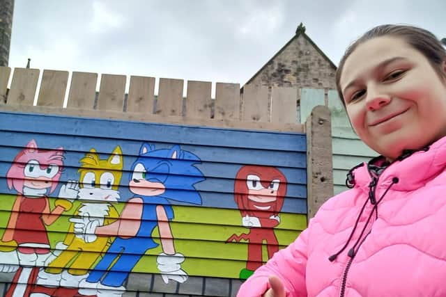 Katelynn Rushe a student at South West College’s Cookstown campus, poses proudly in front of a beautiful Sonic themed mural she painted outside Gortalowry House in Cookstown.