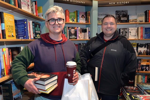 Jack Marshall, left, is well prepared for a quiet weekend with a coffee and a pile of books from the new Waterstones store at Rushmere. Also included is Andrew Gribben. PT41-207.