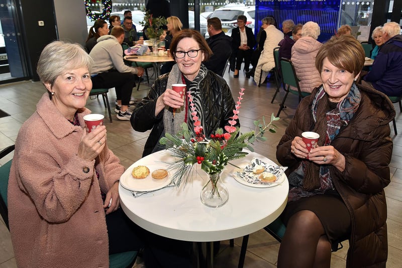 All smiles at the  Ballylisk Car Sales charity coffee morning are, from left, Norma Shanks, Georgie Huddleston and Gloria Neill. PT50-284.