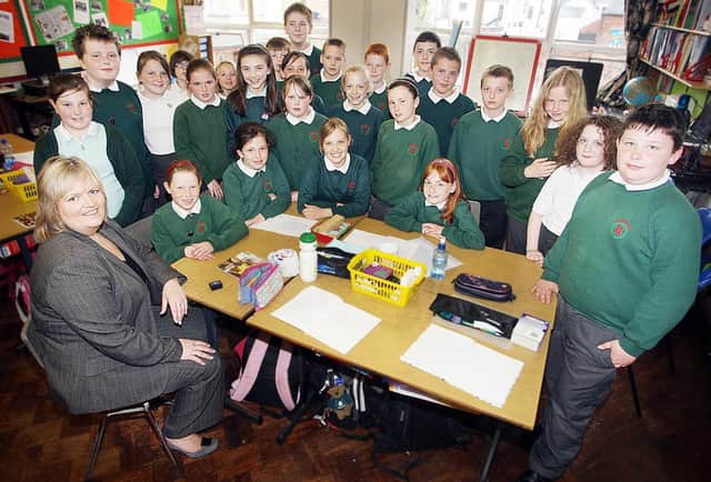 Children's Commissioner Patricia Lewsley pictured in 2009 with children from Brownlee Primary School during a visit to the School