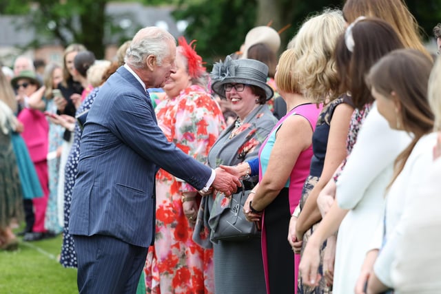 King Charles meets some of the garden party guests.