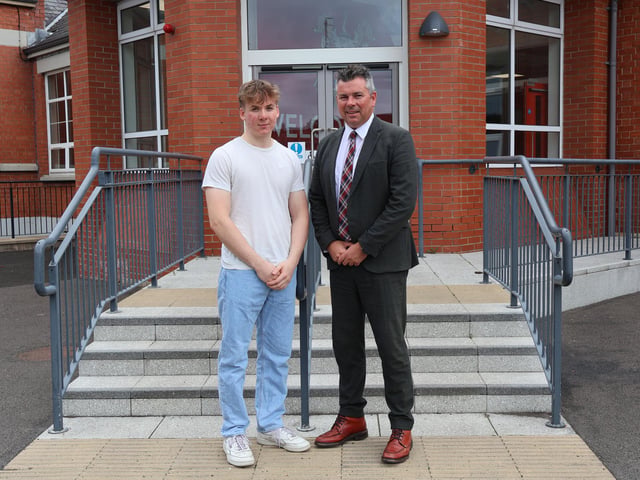 Rainey Headmaster Mr Mark McCullough congratulates a student who achieved 4 A Star Grades.