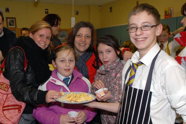 Adam Jackson serves scones made by pupils in home economics at the Brownlow College 2010 open night.