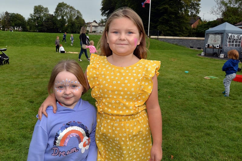 Taking time out from the fun at the charity fun day at Laurelvale Cricket Club are Maddie-Ann Morris (4) and Amelia-Beth Watson (9). PT39-217.