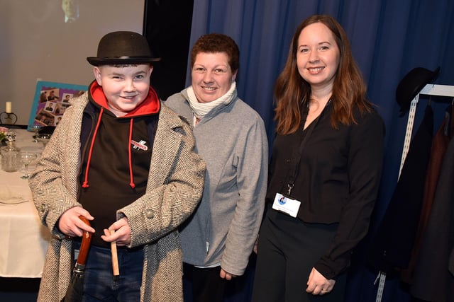 Clounagh Junior High School pupil, Freddie Thompson tries out one of the costumes in the Drama department during the Craigavon Senior High School open night watched by mum, Tracey and teacher, Beth Hand. PT04-216.