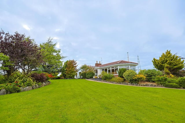Stunning landscaped gardens laid in lawns with an array of mature shrubs and trees set off this lovely home perfectly.