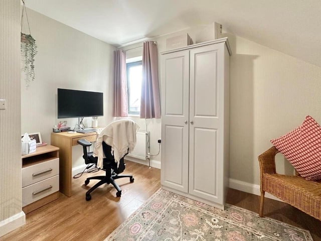 Bedroom with laminate wood floor.