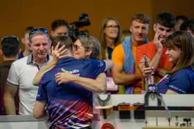 Isaac is embraced by his mum Rebecca with dad Ian looking on.
