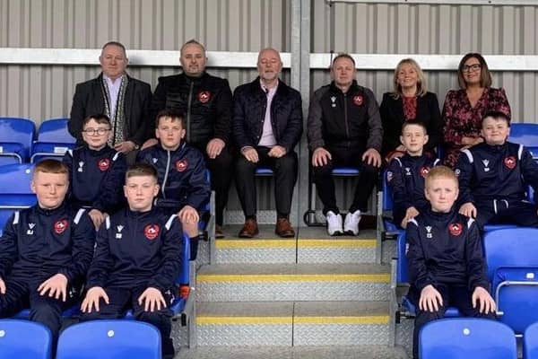 Pictured are Brian Sofley, Managing Director, ASSA ABLOY, Chris Budd, Director of the Lisburn Castlereagh Junior Football League, Andy Tough, Chief Executive, Inspire Business Centre, Chris Finlay, Head Coach, Alderman Amanda Grehan, Janet Little, Boomer Industries, and some of the young players.