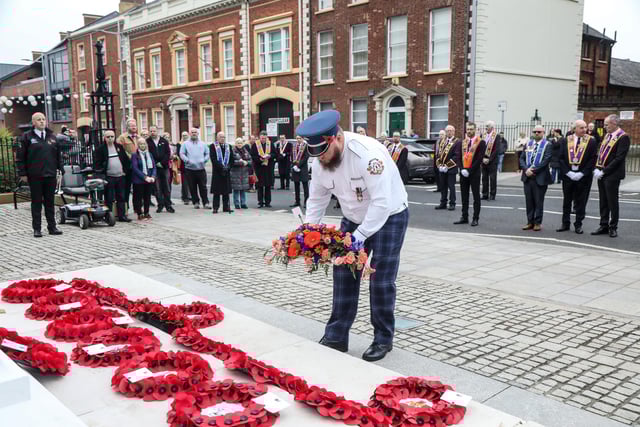 Laying a wreath on behalf of Lambeg Orange and Blue Flute Band