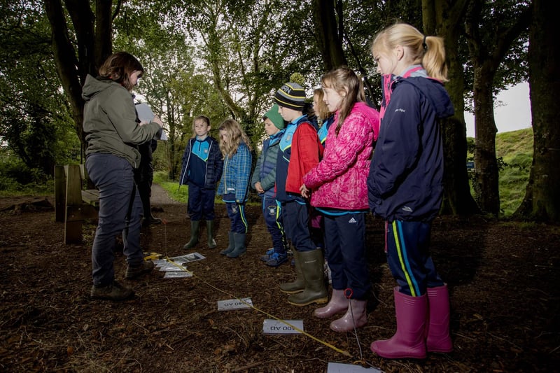 Pupils from St Peter’s and St Paul’s Primary School Foreglen, exploring the history of the Mountsandel site with Grace McAllister of the Causeway Coast and Glens Heritage Trust.