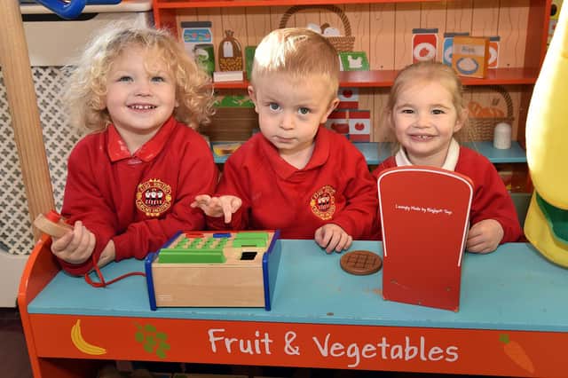Playing in the fruit shop at Kids United Playgroup are pupils from left, Carson, another Carson and Millie. PT99-225.