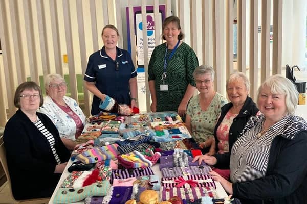 Jennifer Nicholson (Lead Nurse, Unscheduled Care) with Claire Sellar (Presbyterian Chaplain and Designated Chaplain to Inpatients Living with Dementia) with ladies from the Presbyterian Churches who made twiddle muffs for the Ulster Hospital Emergency Department. Pic credit: SEHCT