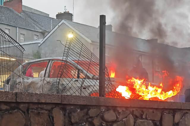 A vehicle alight in Ballymena during disorder in June. Photo: Pacemaker
