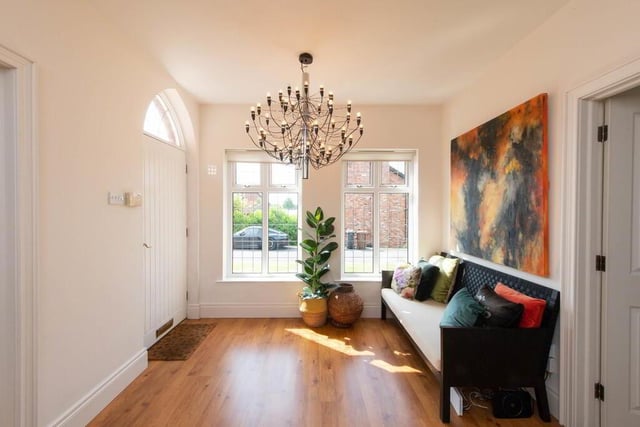 Bright and spacious reception hall with laminate wood flooring.