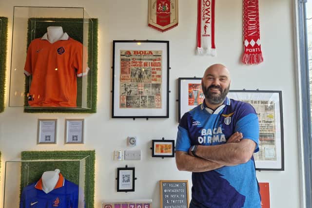 Aaron McIldoon from Portadown has turned his passion for retro football shirts into a business, Vintage Kit Co, and has now set up his first coffee shop and retail outlet in Portadown town centre. Here he is with some retro memorabilia of Portadown taking pride of place in his new coffee shop.