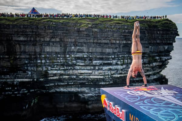 Carlos Gimeno of Spain prepares to dive from the 27.5 metre platform during the final competition day of the fourth stop of the Red Bull Cliff Diving World Series at Downpatrick Head, Ireland on September 12, 2021.  Now the event is coming to Northern Ireland for the first time - to Ballycastle. Credit Romina Amato / Red Bull Content Pool