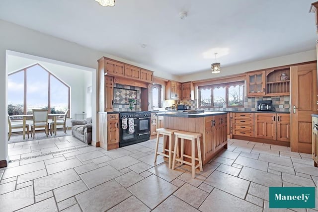 Oak kitchen with an excellent range of high and low level units, and centre island/breakfast bar offering additional storage.