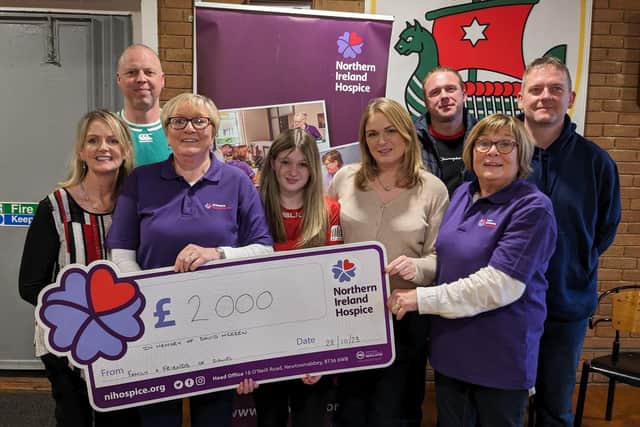 Lynsey and Amy McKeen, the wife and daughter of the late David McKeen, pictured with David's sister-in-law Judith Taylor and some of his friends, presenting a cheque for £2000 to Kay McDowell and Roma Brown of the Larne Hospice Support Group.   Missing from the photo is David's other daughter Alice who was unable to attend.  Photo: Larne Hospice Support Group