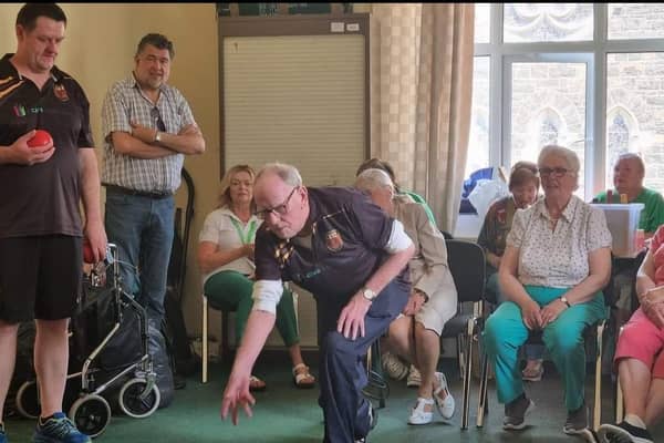 President of Portrush Bowling Club, Uel McCloy giving some coaching to members of the Portrush REACH charity. Credit Donna McCloy