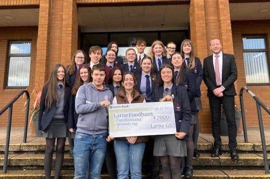 Larne Grammar Charity Committee presents a cheque to Larne Foodbank. Photo submitted by Larne Grammar School.