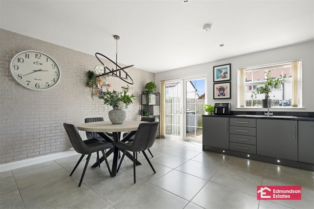 Spacious dining area in kitchen with French doors to rear garden.