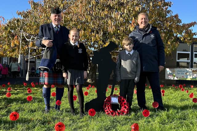 Peter Browne (piper), Poppy Browne (Peter's daughter, Primary 7 pupil), Isaac Rogers (Primary 7 pupil) and Mr Fulton (principal).  Photo: Victoria Primary School
