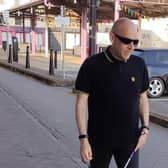 Ballymoney man Alex Patterson pictured walking with his cane. Rarely travelling outside his home town, Alex is now preparing to undertake a sponsored walk from Belfast City Hall to Stormont to raise funds for the charity DeafBlind UK. Credit Deafblind UK