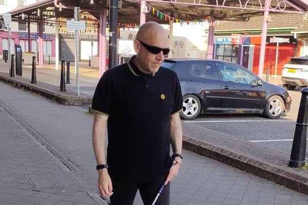 Ballymoney man Alex Patterson pictured walking with his cane. Rarely travelling outside his home town, Alex is now preparing to undertake a sponsored walk from Belfast City Hall to Stormont to raise funds for the charity DeafBlind UK. Credit Deafblind UK