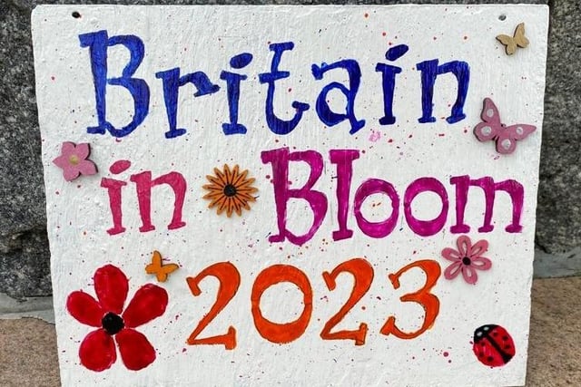 A wonderful slate hand painted sign on display in the Diamond, Coleraine, made by The Crafty Cuppa Club to celebrate Coleraine’s Britain in Bloom large town entry in Britain in Bloom 2023.