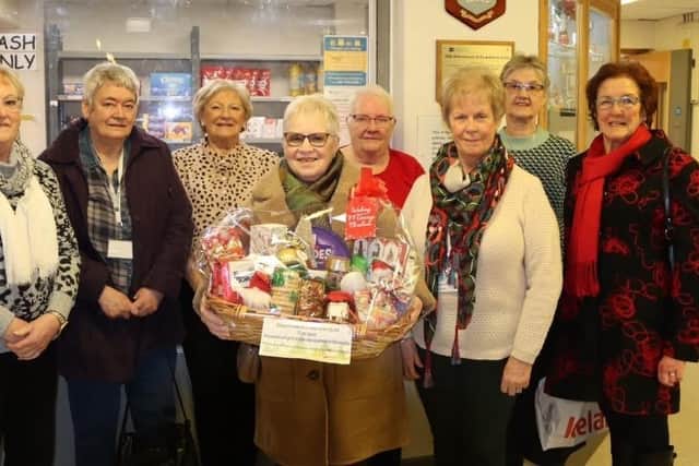 Dorothy Andrews (Treasurer), Pauline Heaney (Former Chairperson) and Kate Coil (Chairperson) with members of the Ex-Patients Guild at the Lagan Valley Hospital. Pic credit: SEHSCT