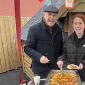 Maddison Brown, Highway Kitchen volunteer, serves up some of the treats at the Foods of the World. Pic credit: Housing Executive