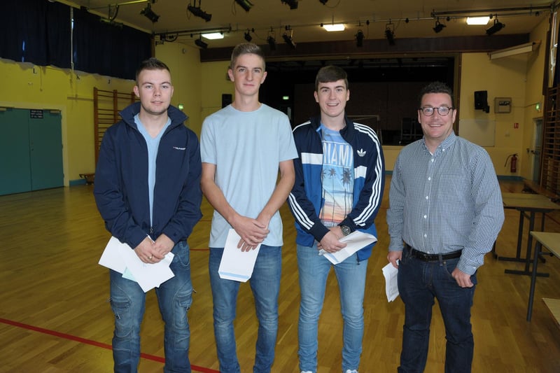 Carrickfergus College students Jamie Todd, who gained ABB in his A Levels; Jordan Moore, who gained BBC in his A Levels, and Daryl Clarke who achieved A*and B pictured during results day in 2015.  Also pictured is teacher, Mr McCready. INCT 33-200-AM
