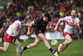 Armagh's Callum O'Neill drives past Derry's Ethan Doherty and Conor Glass during their league meeting in March.