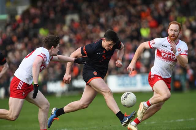 Armagh's Callum O'Neill drives past Derry's Ethan Doherty and Conor Glass during their league meeting in March.