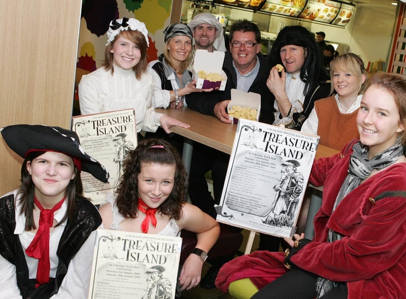 On hearing that McDonalds were serving up nuggets, Long John Silver (Mark Crawford) and his band of pirates paid manager Bruce Bailie a visit to steal some! When the cast of the Provincial Players arrived they were delighted to receive sponsorship for their pantomime "Treasure Island" back in 2010. Also included is Zara Levear (Jim Hawkins), Jeni Campbell (Polly) and Leroy Dempster (Mehat)